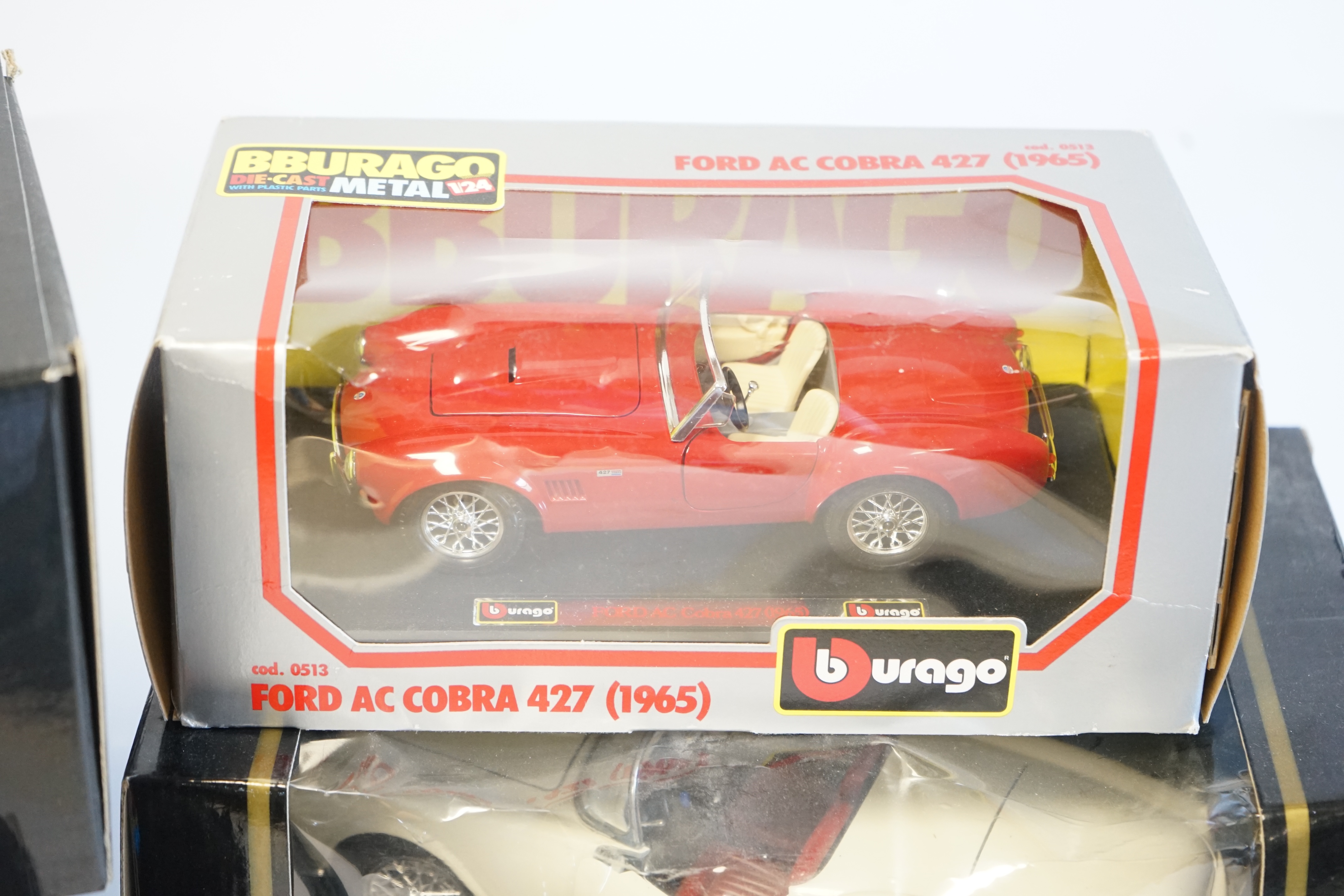 Six boxed Burago Diecast racing cars, five in 1/18 scale including; a Mercedes-Benz SSK, a Mercedes-Benz 300SL, a Jaguar SS100, a Lancia Aurelia B24 spider and an Alfa Romeo 2300 spider, together with a 1/24 scale Ford A